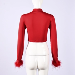 Detail of red mock neck crop top featuring faux fur cuffs and elastic slim fit fabric