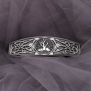 Macro view of vintage silver Celtic Tree of Life hair clip with intricate knot patterns