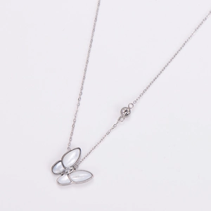 Detailed view of silver butterfly necklace with white shell wings and crystal accents