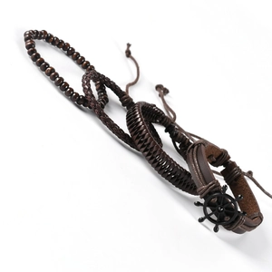 Three-piece brown leather bracelet set with wooden beads and a black ship helm charm