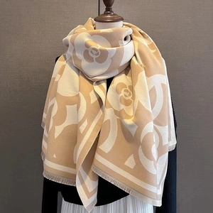 Classic beige camellia jacquard cashmere scarf with fringed edges on wooden mannequin