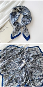 Detailed view of paisley patterned square silk scarf in elegant blue, grey and white tones
