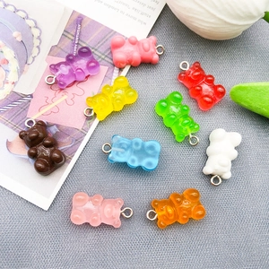 Close-up of nine colorful resin bear charms with metal rings for DIY jewelry making
