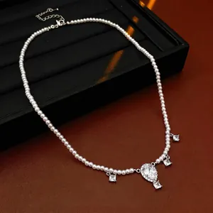 Elegant beaded pearl necklace featuring a large teardrop and square zircon pendants