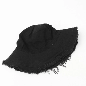 Detailed view of the frayed edges on a black cotton canvas bucket sun hat