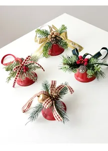 Detailed close-up of red frosted Christmas bells with pine cones and festive bows