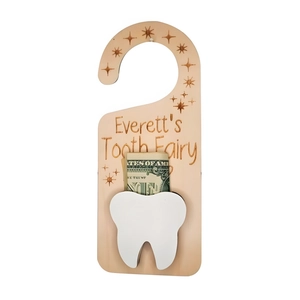 Detail of wooden tooth fairy door hanger featuring white pocket and personalized engraving