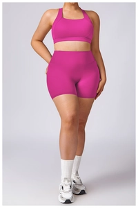 Plus size rose pink workout set featuring a cross-back sports bra and high waist shorts