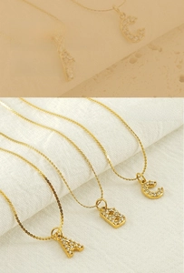 Detailed macro view of gold-plated initial pendants with sparkling zircon inlays