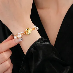 Double layer freshwater pearl bracelet with gold plated clasp on black velvet