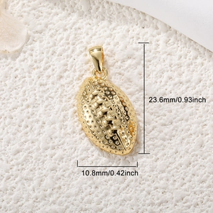 Macro detail of a gold football pendant with size dimensions 23.6mm by 10.8mm