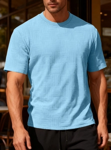 Detailed close-up of light blue men's T-shirt showing geometric waffle texture fabric