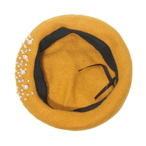 Close-up of yellow wool beret featuring elegant white pearls and sparkling rhinestones