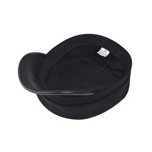 Detail view of cotton-polyester blend lining and care label inside black newsboy hat