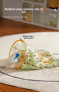 Detail of green cat tunnel toy featuring side holes and hanging mouse toy for indoor play