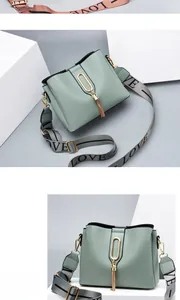 Close-up of light green bucket bag featuring gold metal buckle and LOVE woven strap