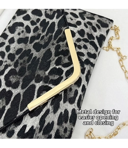 Close-up of leopard print envelope bag with bright gold L-shaped hardware and metal chain