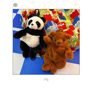 Detail of plush animal backpacks featuring panda and brown bear designs on a colorful bed