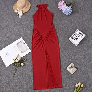 Detail of red halter neck dress featuring ruched waist and high slit design