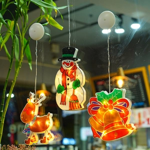 Warm white LED Christmas suction cup lights with Reindeer and Snowman on a window