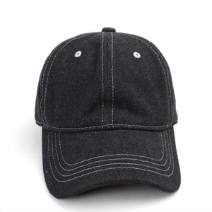 Detail of black washed denim baseball cap with white contrast stitching and air vents