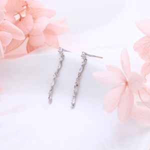 Detailed macro view of S925 sterling silver chain earrings with zircon tassels