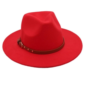 Close-up of a red wool fedora featuring a brown leather belt strap and metal buckle detail