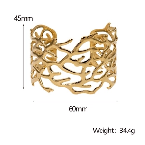 Detailed view of irregular hollow gold cuff with 45mm height and 60mm width dimensions