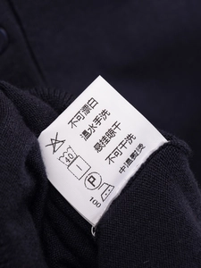 Primo piano dettagliato dell'etichetta di lavaggio con istruzioni su maglia nera