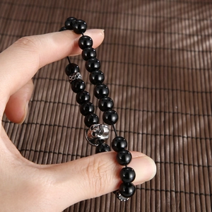 Natural agate tiger eye stone bead bracelet with stainless steel skull charm in hand