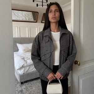 Chic grey herringbone jacket for women with lapel collar and casual zip-up pocket details