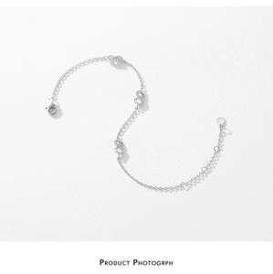 Macro shot of S925 sterling silver Mobius bracelet featuring cubic zirconia infinity links