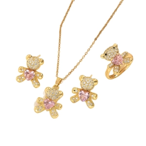 Golden bear jewelry set with necklaces and earrings featuring pink heart gemstones