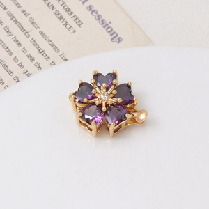 Macro detail of a golden flower clasp with a purple heart-shaped stone for jewelry
