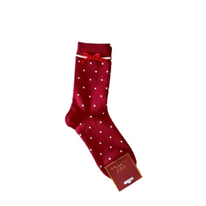 Thick red festive Christmas socks with white polka dots and velvet bow decoration
