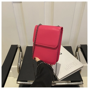 Detail of rose pink faux leather mini crossbody bag with dark metal chain strap