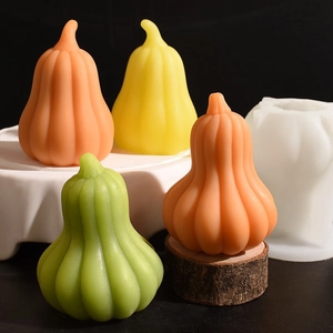 Halloween pumpkin silicone mold with colored plaster crafts on a dark background