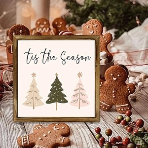 Close-up of wooden frame wall art with 'tis the Season' text and stylized Christmas trees