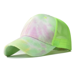 Detail of tie-dye baseball cap featuring neon green mesh and breathable fabric texture
