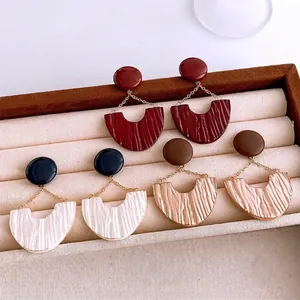 Three pairs of elegant U-shaped pleated drop earrings in burgundy, ivory and champagne gold