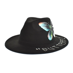 Detail of black felt fedora featuring colorful butterfly print and BUTTERFLY text on brim
