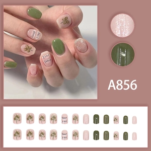 Press-on nail set with 24 olive green and pink pieces featuring clover and Good Luck text