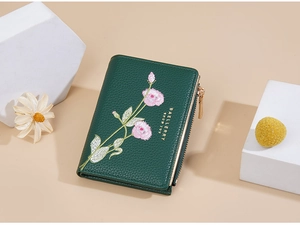 Close-up of green PU leather wallet featuring elegant floral embroidery and a gold zipper