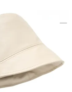 Detailed close-up of cream PU leather bucket hat showing fine texture and neat stitching