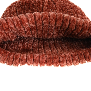 Detailed close-up of brick red chenille knitted beanie showing thick textured fabric weave