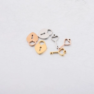 Polished stainless steel heart-shaped lock and key charms in gold, silver, and rose gold
