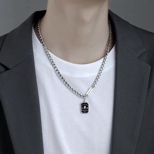 Men's silver Cuban chain necklace with a black rectangular tag pendant and Good Luck engraving