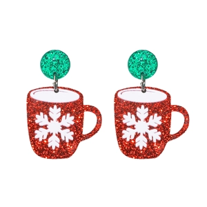 Macro detail of Christmas coffee cup earrings with glitter and snowflake pattern