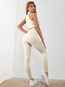 Detail of ribbed knit yoga set showing cream white texture and high waist slim fit