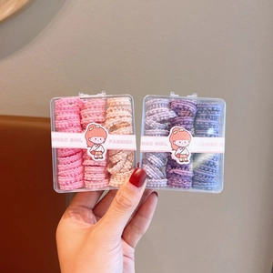 Two boxes of colorful wave telephone cord hair ties for girls in pink, blue, and purple